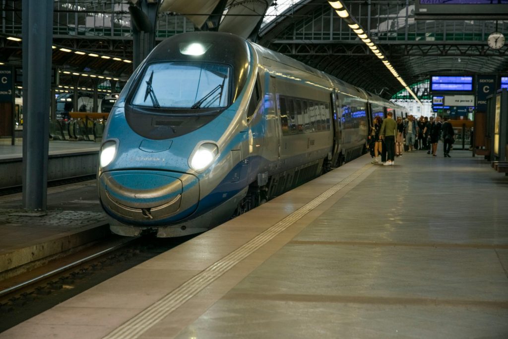 High-speed train arriving at Wrocław's bustling station platform.